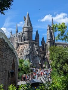 a group of people standing in front of a castle